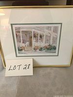 Front view of framed print showing the artwork of a house with flowers and dogs on the porch, framed in gold with double matting.