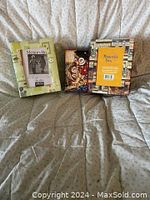 Three decorative memory boxes on couch showing front and back sides