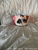 Photo showing the ceramic winter festive bowl with snowman design on a fabric background.