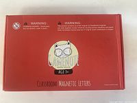Closed red box of Gamenote Classroom Magnetic Letters showing brand, age 3+ marking, and warnings.