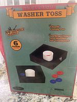 Full box front showing branding, product image, and included washers (6 washers, 3 red and 3 blue).