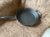Top view of Lagostina cast iron skillet showing cooking surface, pouring spout, and handles.