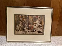 Framed Tom Thomson print showing snowy forest with trees and foliage.