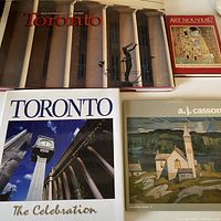 Photo showing all four coffee table books stacked together with full original dust jackets: two about Toronto, one Art Nouveau art book, and one Canadian artist A.J. Casson art book.