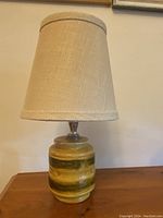 Full view of the lamp with the burlap shade, showing the lamp's size and color.