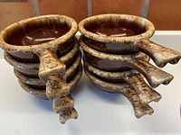 Stack of 8 ceramic handled bowls showing the textured cream drip border on handles.