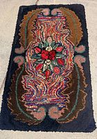 Full view of American antique hooked rug showing entire design and colors.
