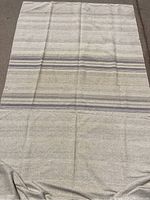 Woven grain sack fabric with beige, blue and gray stripes, laying flat, showing pattern and condition including some minor stains.