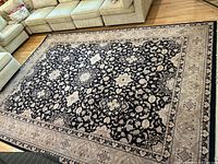 Rug laid out on hardwood floor in living room showing overall pattern