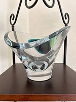 Kosta Boda vase angled to show the thickness and curvature of glass with internal blue-green swirl