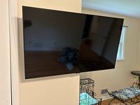 Front view of Samsung 43-inch flat screen TV mounted on wall showing sleek black screen and slim bezel.