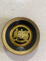 Top view of the round decorative plate with Australian coat of arms in 24k gold plating.