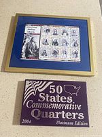 Framed American Indian Chiefs stamps and closed purple box of 50 States Commemorative Quarters 2004 Platinum Edition