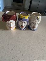 Full view of the three Lawrence of Arabia inspired character mugs displayed on a kitchen counter.