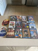 Photo showing 15 DVDs including Casablanca, Yours Mine & Ours, Bewitched TV Series, Patton, Radio, The Lost Boys and more.