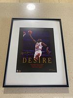Framed limited edition Michael Jordan print with number 3091/5000, showing Jordan leaping to dunk and 'DESIRE' text