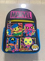 Front view of mini Marvel backpack showing colorful comic style pop art featuring Groot, Spiderman, Captain America, Iron Man and Marvel logo.