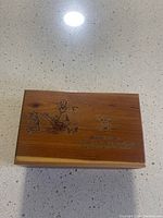 Closed cedar box showing engraved image of Robert E Lee sitting on a horse and text on the lid.