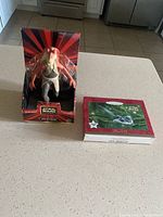 Jar Jar Binks figurine in original packaging alongside a rectangular box containing the Star Wars ornament.