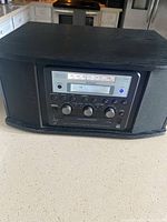 Front view of Teac music player showing radio FM tuning display and controls.