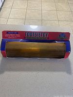 Original Tootsietoy freight line box with clear plastic display window showing train pieces and colorful graphics with brand and origin text.