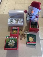 Full view of Christmas ornaments and plush snowman, showing all items.