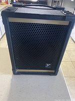 Front view of black Yorkville speaker amplifier showing metal grille and logo.