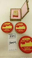 Photo showing the carved stone stamp in decorative box alongside three red tins of Beijing Yinni ink.