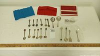All spoons and accessories laid out showing quantity and condition