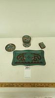 Full set of four enamelware items: a rectangular tray, a lidded cylindrical box, a round dish, and a small rectangular box, all decorated with brown and beige dragon designs on teal background.