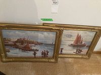 Two framed coastal maritime pictures depicting sail fishing boats near the harbor with people watching and interacting by the shore, frames golden ornamental style, size 16x21 inches