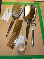 Full overview of all items in the sterling silver vanity set and additional accessories.