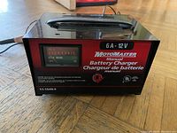 Motomaster battery charger front view showing meter and manual control.