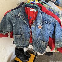 Denim children's jacket with elastic waist and big pockets, red lining visible inside, PAC-DOG label and patch on front