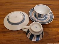 Bottom view showing the base of one cup and saucer with maker's mark and pattern detail