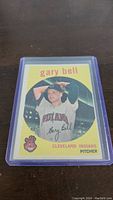 Front view of the 1959 Topps Gary Bell rookie baseball card #327 in protective sleeve, showing player image, name, and team.