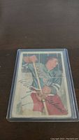 Front of 1953-54 Wally Hergesheimer hockey card in plastic sleeve, depicting him in New York Rangers uniform.