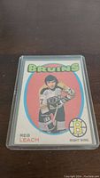 Front view of the 1971-72 O-Pee-Chee Reg Leach rookie hockey card showing player image, team logo, and card details.