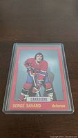 Front view of 1973-74 O-Pee-Chee Serge Savard hockey card, showing player in Canadiens uniform with name and number.