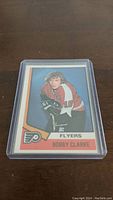 Front of 1974-75 OPC Bobby Clarke #260 hockey card showing player image and team.