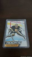 Front of the Jeremy Swayman rookie card showing him in goalie gear with 'ROOKIE' label and team logo.