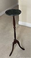 Side view of plant stand showing dark wooden tripod legs and green marble top