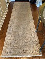 Full-length view of beige neutral runner laid in hallway