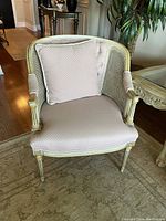 Front three-quarter view of chair with matching pillow on seat