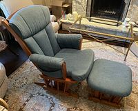 Padded wooden frame rocking glider chair with matching footrest stool upholstered in blue-green fabric, showing overall condition and size.