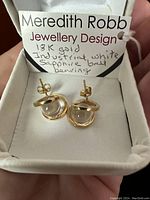 Earrings in presentation box with branded tag