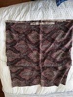 Folded angle showing entire piece and Liberty of London brand tag on fabric.