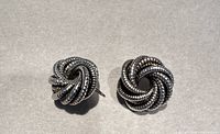 Photo of sterling silver stud earrings with twisted rope knot design on neutral background