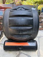 Front view of black EnvirCycle compost tumbler mounted on base