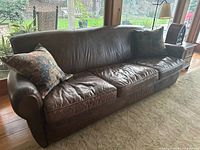 Front angle view with pillows showing full sofa and overall condition